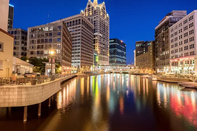 Downtown Milwaukee on the river walk at night.